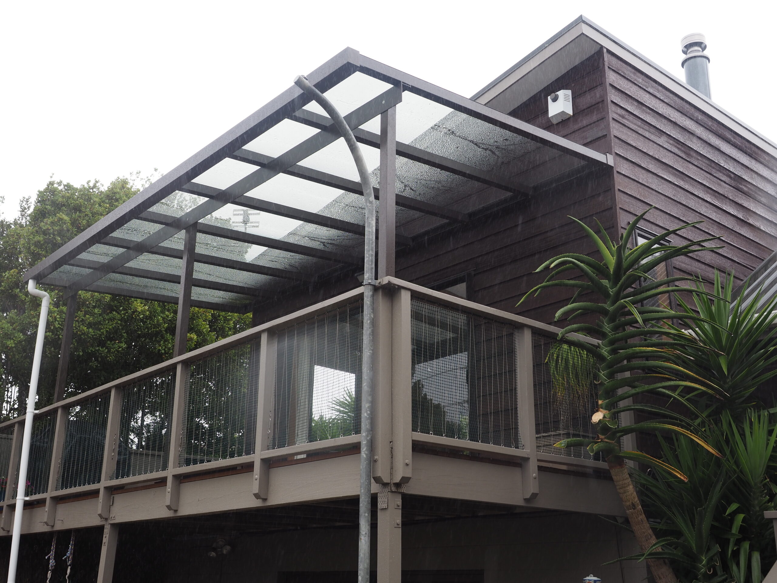Minimalist cantilever awning over suburban Auckland entryway